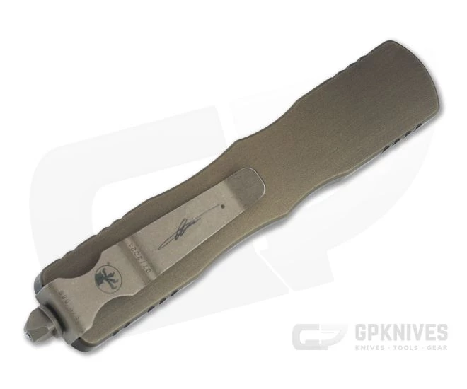 Microtech Signature Dirac D/E Antique Bronze Apocalyptic Full Serrated M390 OTF Automatic 225-15APABS 2 Microtech Signature Dirac D/E Antique Bronze Apocalyptic Full Serrated M390 OTF Automatic 225-15APABS - Image 2